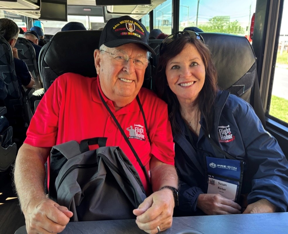Judge Barber sitting inside a bus next to United States Army veteran Sandy Parrott