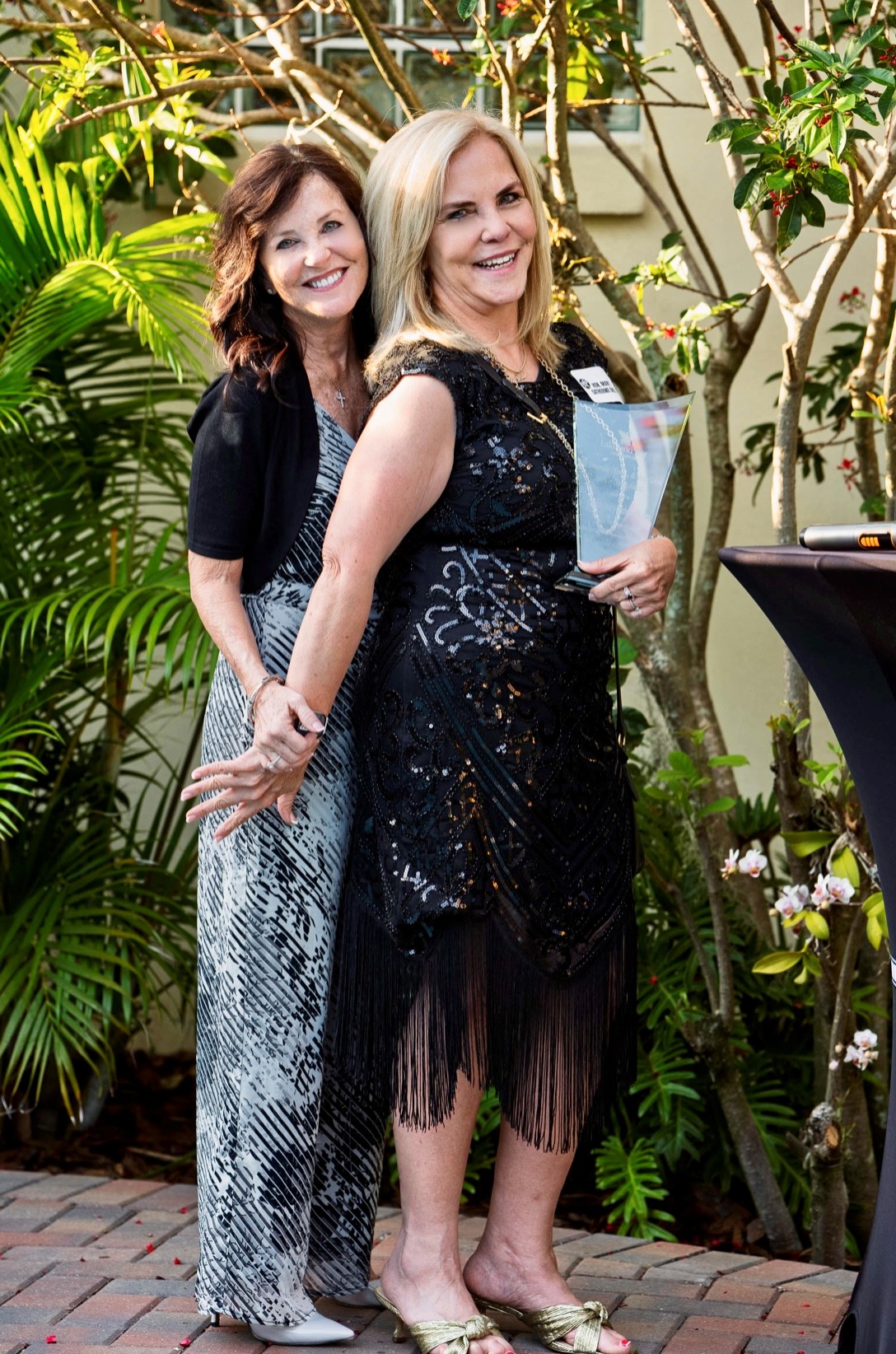 Judge Green is holding her Oliver and Mona Green Spirit of Giving Award in her left hand and standing next to Judge Barber